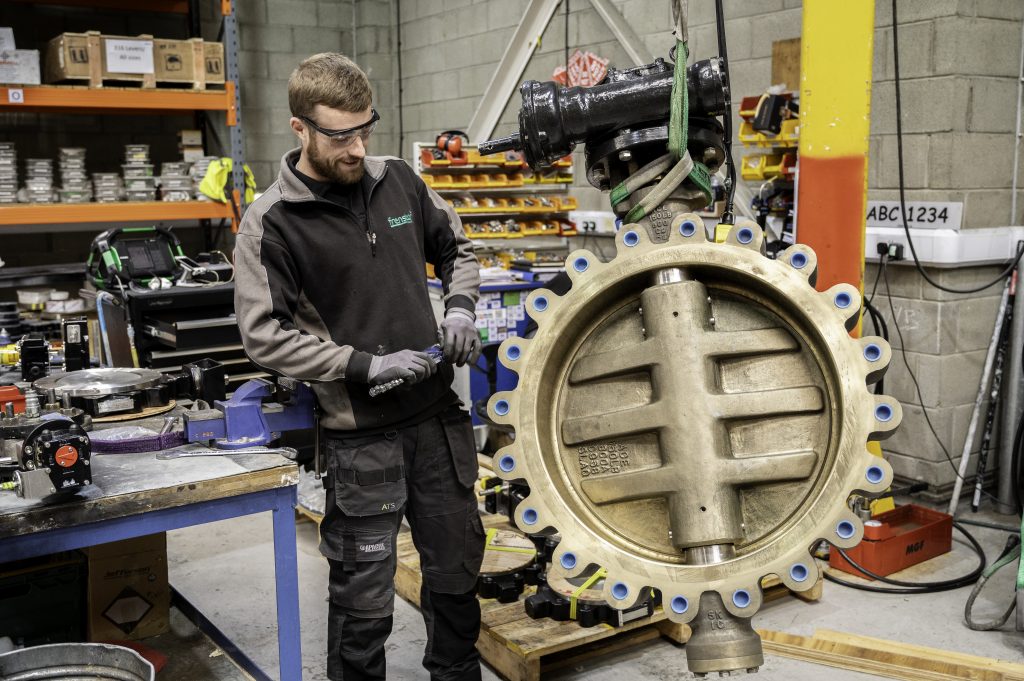 An image of a Frenstar butterfly valve beside a member of the team